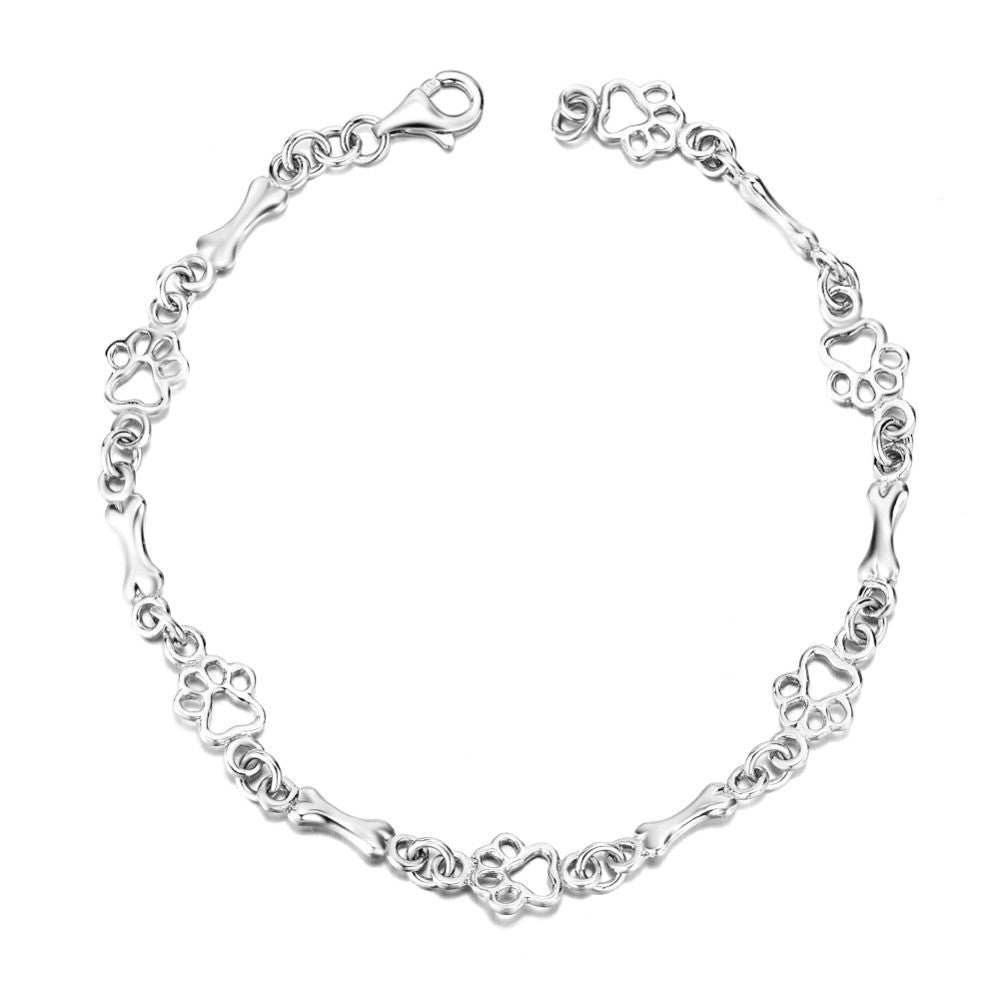 PULSERA DE PLATA CON DIJES DE HUELLA Y HUESO